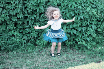 Cute little girl  on the meadow in spring day