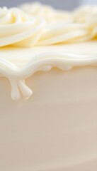 close up of a frosted cake with white icing