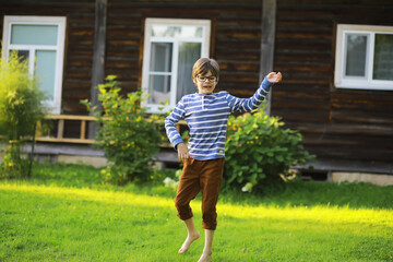 Happy little girl with flowers in the field