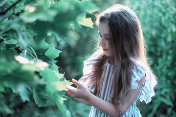 Cute little girl  on the meadow in spring day