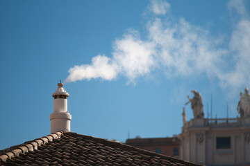 White smoke rises from the chapel chimney, indicating the successful election of a new pope during the papal conclave.