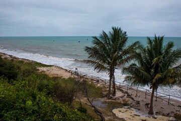 Stormy skies and waves along the sandy beach at Inhassoro in Mozambique. Inhassoro is a small...