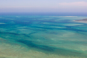Aerial view of the shallow ocean with its submerged sandbars and tidal channels in the Mozambique channel of the Mozambique coast at Vilanculos.