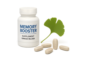 A bottle labeled Memory Booster with supplements and a Ginkgo Biloba leaf beside it. Concept Memory Enhancement, Ginkgo Biloba Benefits, Cognitive Health Supplements, Natural Memory Aids