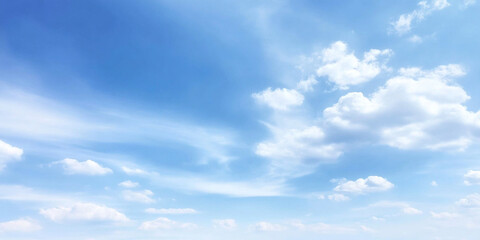 Obraz premium Wide angle view of vibrant summer sky filled with fluffy white clouds against bright blue backdrop, evoking sense of tranquility and openness