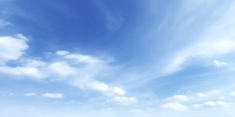 Obraz premium Puffy summer clouds suspended in wide open blue sky create serene and tranquil atmosphere, inviting feelings of peace and relaxation