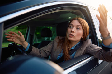 Mid adult businesswoman feeling stressed due to traffic jam.