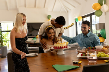 Obraz premium Friends gathering around birthday cake, celebrating and smiling at home party