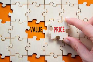 Price and Value symbol. Concept word Price and Value on wooden puzzle. Businessman hand. Beautiful...