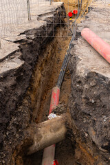 Repair of sewage heating systems or electricity. A trench has been dug in the ground, from which a...