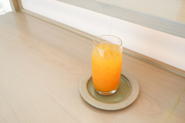 Glass of freshly squeezed orange juice on the table with citrus fruits,Fresh orange juice in glass,Space for text..