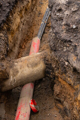 Repair of sewage heating systems or electricity. A trench has been dug in the ground, from which a...
