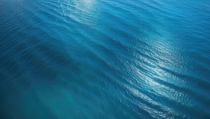 Overhead drone shot of sea with blue water backdrop.
