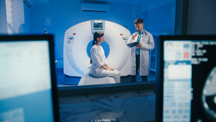Thoughtful physician holding chin and reviewing diagnostic notes behind glass with scans displayed.