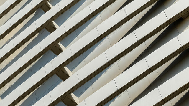 Abstract architectural detail of modern building facade with diagonal parallel lines and shadows in Saudi Arabia