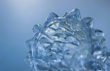 Gear Shaped Icicle Isolated on Soft Blue Background
