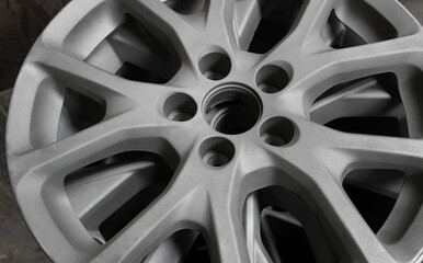 Priming before paint coating of sporty design wheel rims. Paint shop of car styling workshop
