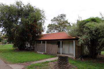 The house estate in the village is surrounded by green trees and bushes.