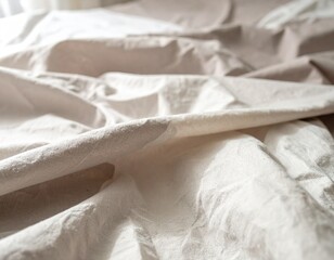 Obraz premium A close-up of beige and cream-toned linen bedding, showing soft textures, natural