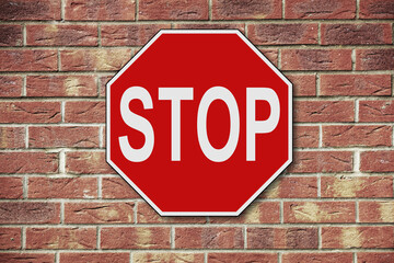 Stop sign on brick wall background