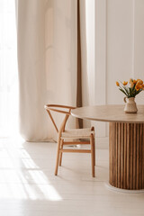 cozy light kitchen with a dining table and chairs