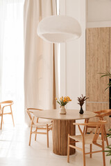 cozy light kitchen with a dining table and chairs