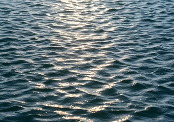 Obraz premium Sparkling Water Surface Texture Ripples and Sunlight Reflections. Beautiful Water Surface for Background, Ocean, Lake