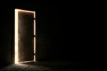 An ajar door in a dark room with a ray of light. Space for text.