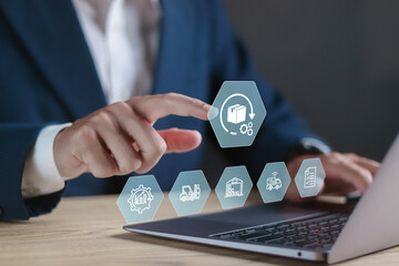 Shipping and Receiving concept. Supply Chain and Logistics Management Process. Person using laptop with warehouse management icon on virtual screen.