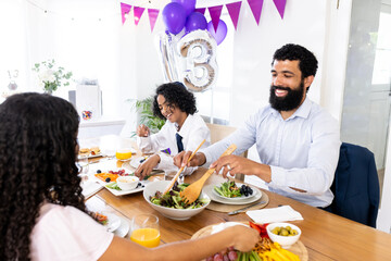 Celebrating special occasion, family sharing festive meal with joy and laughter together