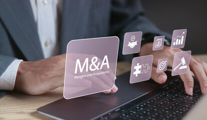 Mergers and acquisitions business concept. M and A deal partnership. Enhance the company's growth and stability. Businessman using laptop with M and A text on on virtual screen.