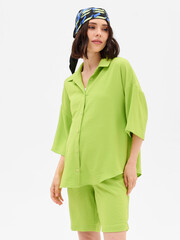 Pregnant girl model in stylish clothes on white background in studio.