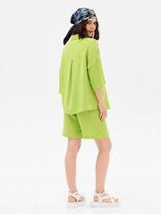 Pregnant girl model in stylish clothes on white background in studio.