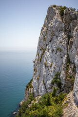 High Limestone Mountain with Sea in Gibraltar. Vertical Scenery of Rock Formation with Water.