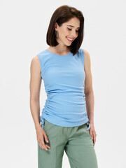 Fototapeta premium Pregnant girl model in stylish clothes on white background in studio.