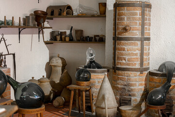 Historic workshop showcasing traditional glassblowing tools and equipment in an artisan studio in a quaint town