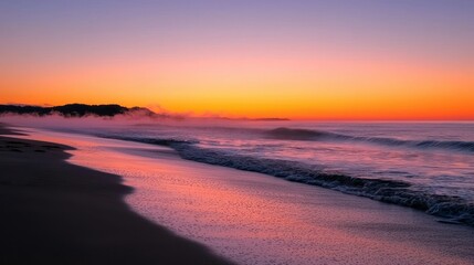 Obraz premium Beautiful sunrise over calm ocean water with hazy atmosphere