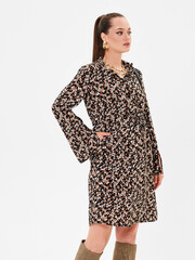 Pregnant girl model in stylish clothes on white background in studio.