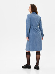 Pregnant girl model in stylish clothes on white background in studio.