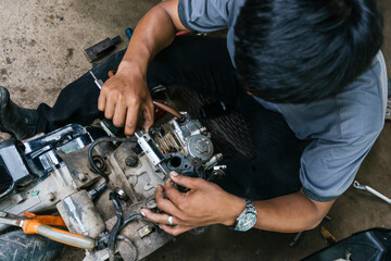 Mechanic Skillfully Repairing Motorcycle Engine Components