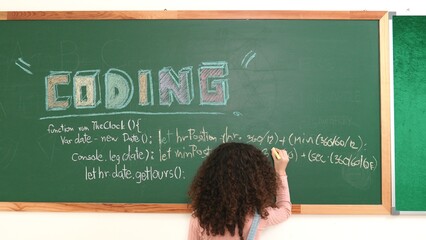 Smart american girl writing engineering prompt and programing system while standing blackboard with...