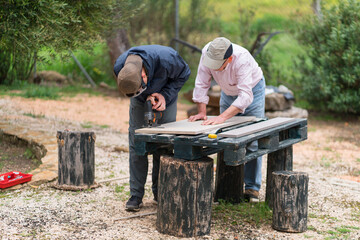 Senior father and son engaging in outdoor carpentry work