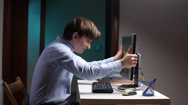 Stressed office worker yelling at computer and pulling hair out