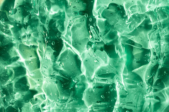 Mesmerizing green gel texture with light reflections