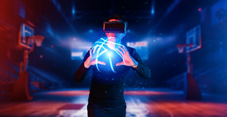 Basketball player holding basketball hologram at futuristic sport arena. Energetic athlete or sport person practicing basketball skill by using augmented reality technology. Innovation. Ingenuity.