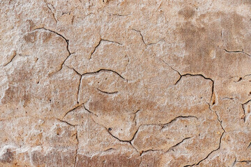 Close up view of cracked concrete surface, highlighting texture, weathering, and the effects of time