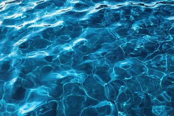 Calm blue water surface reflects sunlight in tranquil pool during midday light