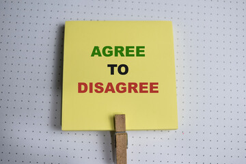 Concept of Agree to Disagree write on sticky notes isolated on Wooden Table.