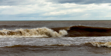The waves of the lake Michigan crashing on the shore