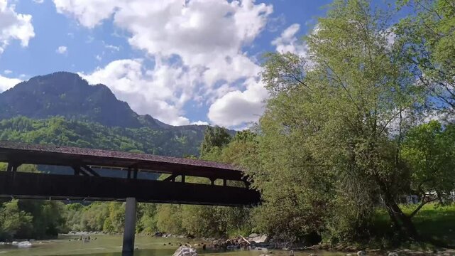 Breathtaking timelapse of KramsachвЂ&trade;s iconic bridge against the stunning Tyrolean landscape and vibrant clouds
